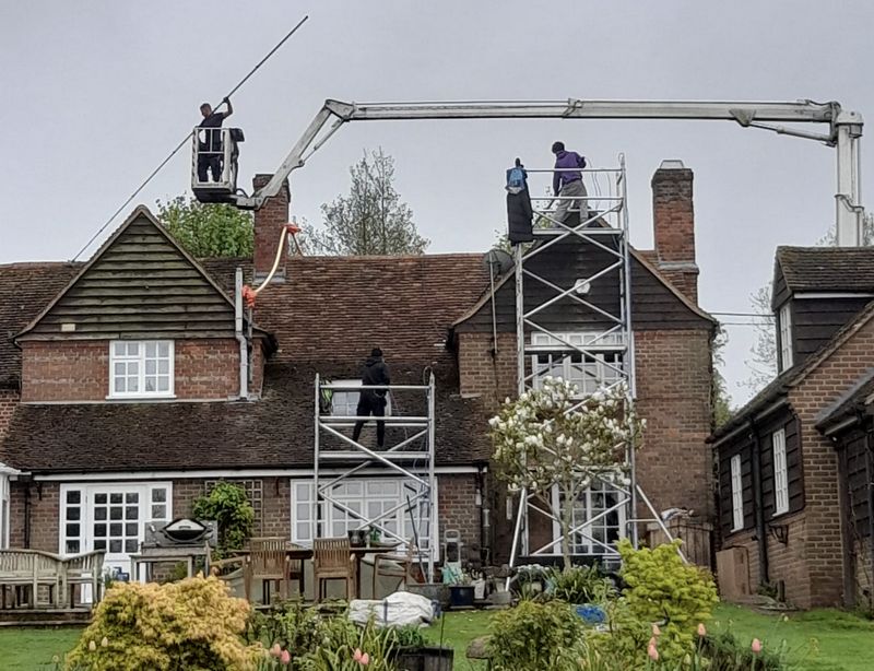 The Moss Cleaners using cherry picker and scaffolding to clean roof safely and professionally in Totton, Hampshire